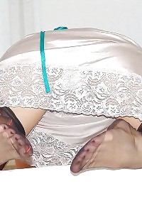 Kelly Dee Poses On The Bed Having Fun With Her Stockings And Satin Skirt